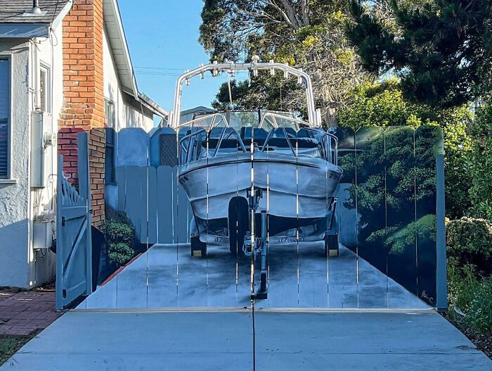 Neighbor Gets Told To Hide His Boat, Turns Fence Into A Masterpiece
