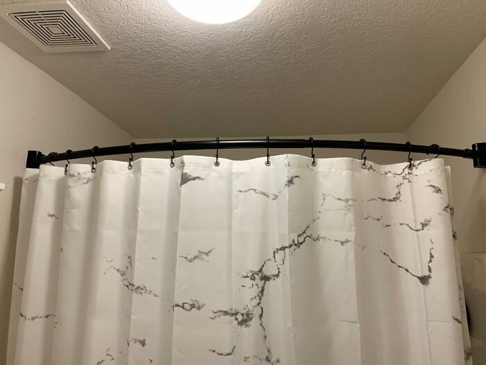 Say Goodbye To The Cold Shower Curtain Attacks With This Curved Shower Curtain Rod