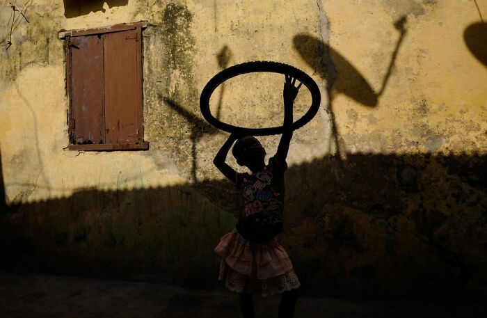"A Girl Playing With A Tire", Ghana, Cape Coast, 2018
