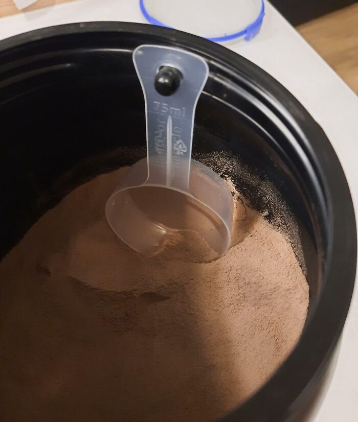 Whey Protein Container Has a Hook to Hang the Scoop. Fancy!