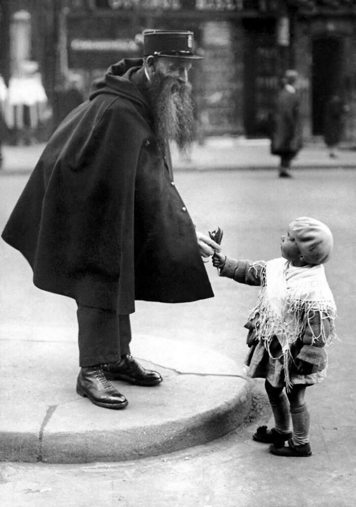 Lil’ Florist Hands Over Blossoms to Officer in Paris, circa 1920