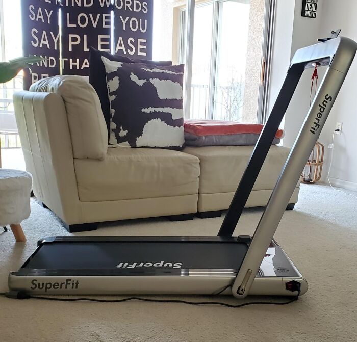 This Folding Treadmill Slides Under Your Couch, Saving You From Becoming Your Apartment's Clothes Rack