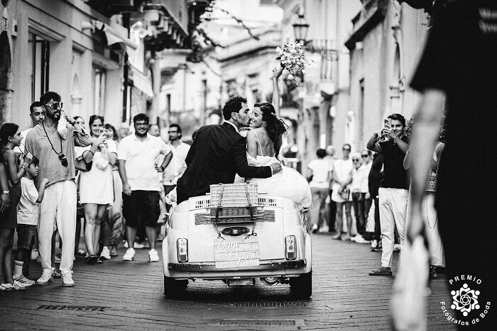 When Love Fits In A Tiny Car… And The Whole Town Shows Up To Watch. Photo By Carmelo Ucchino