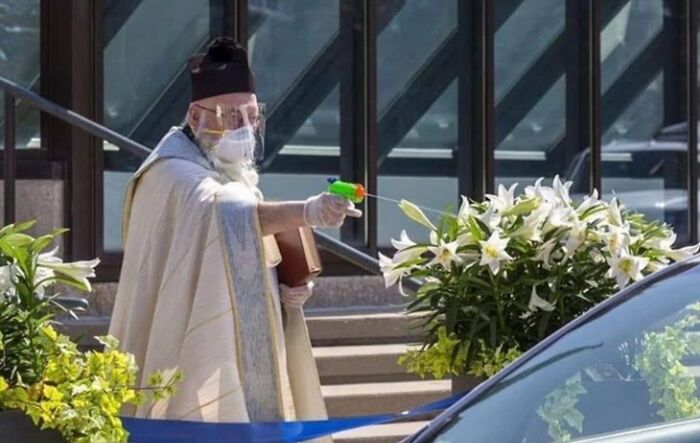 Priest Sprays Social Distance Blessings with a Squirt Gun (Holy Water, We Hope)