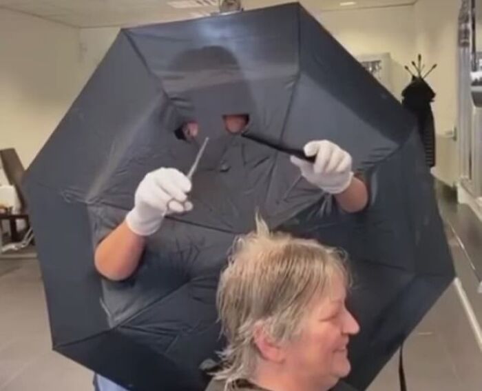 Dutch Hairdresser Uses Umbrella as Client Shield