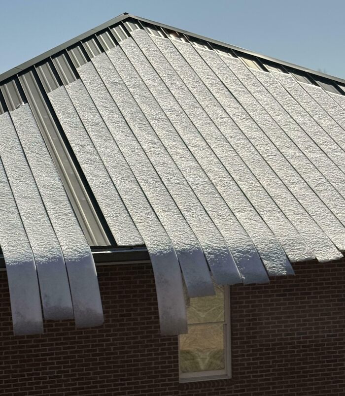 Ice Bending While Sliding Off a Tin Roof—Nature’s Little Dance