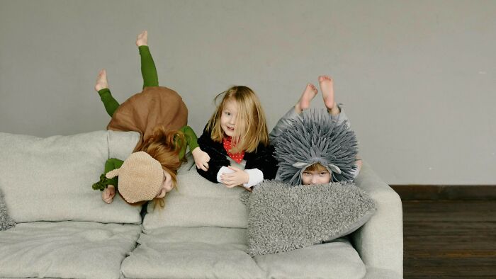Playing the floor is lava (or shark infested water) game, leaping from couch to table like a tiny acrobat.