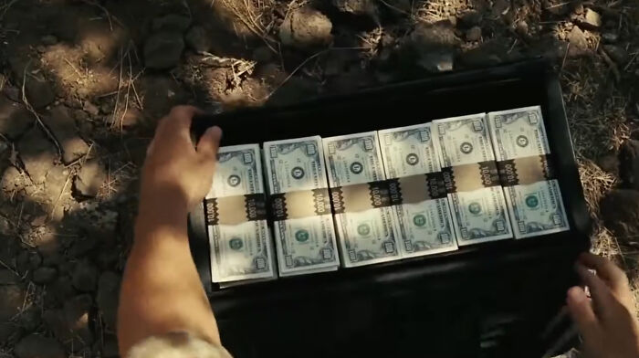 Llewelyn in No Country for Old Men grabs a mysterious suitcase of money after a bloodbath—because, who wouldn’t? Heads up, bad luck incoming.