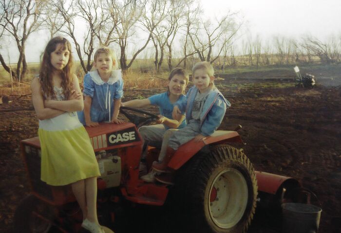 Siblings At Childhood Home, Looking Like An Epic 1990 Farm Band