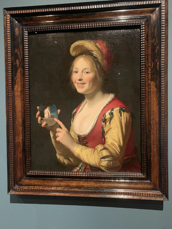 “Smiling Girl, A Courtesan, Holding An Obscene Image” By Gerard Van Honthorst, 1625