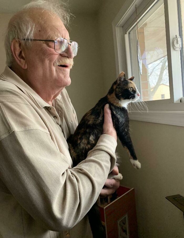 Grumpy Dad Holding Up The Cat To See Outside (Soft Spot Alert)