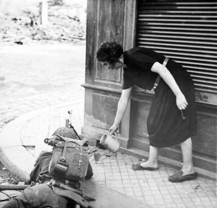 French Lady Offers Cider to British Soldier in Lisieux, 1944