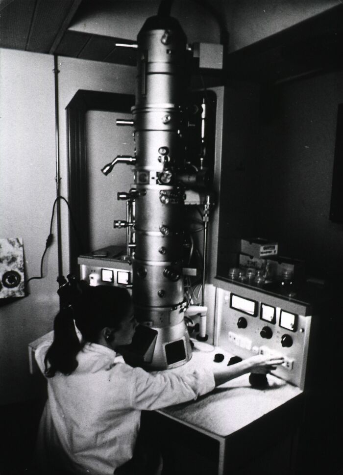 Microscope Towering Over Everyone, 1930s