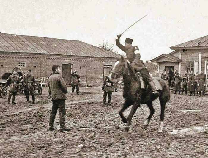 Cossack Policeman Shows Off Sword in Front of Laughing Hungarian Soldiers, 1941