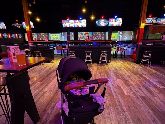 Nap Time at the Bowling Alley? Yep, Dad's Doing It Right