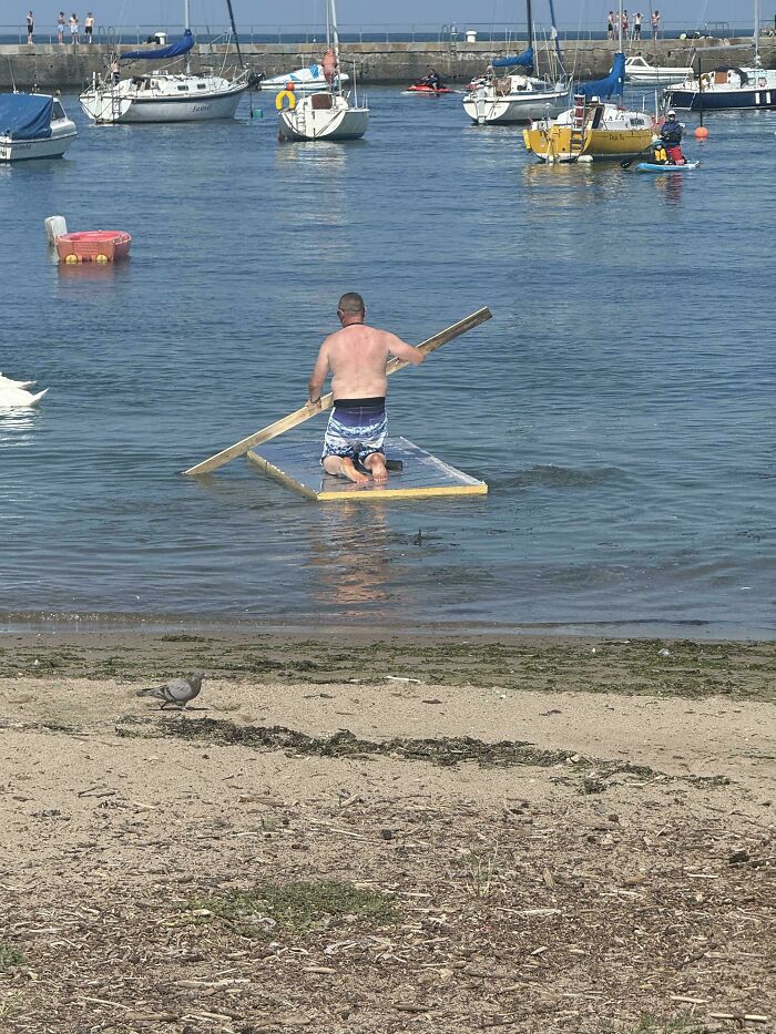 Middle-Aged Man Rows Insulation Board Like a Madlad Pirate