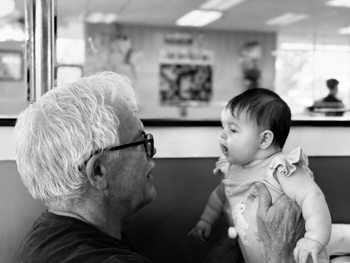 Classic Dad Pose: Holding The Grandkid Like A Pro