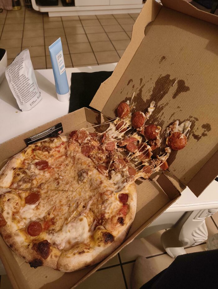 Delivery Guy Holds Pizza Like a Vertical Flag