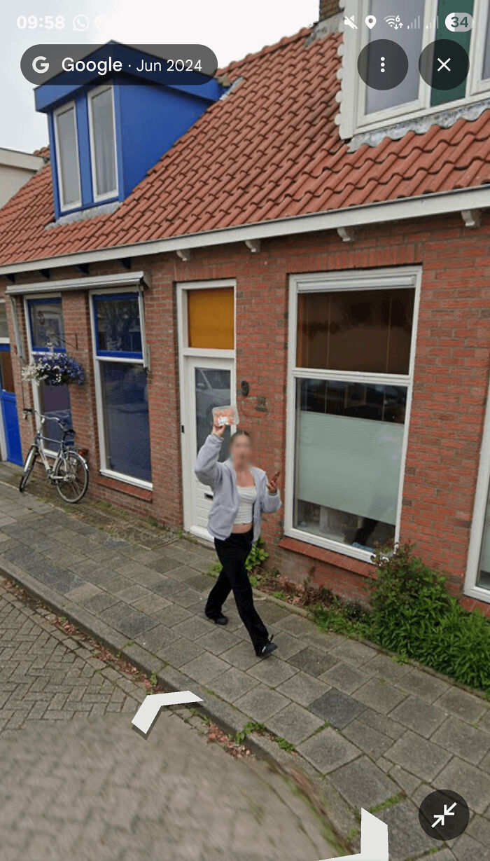 Woman Waving At Street View Car... Holding Chicken Drumsticks?