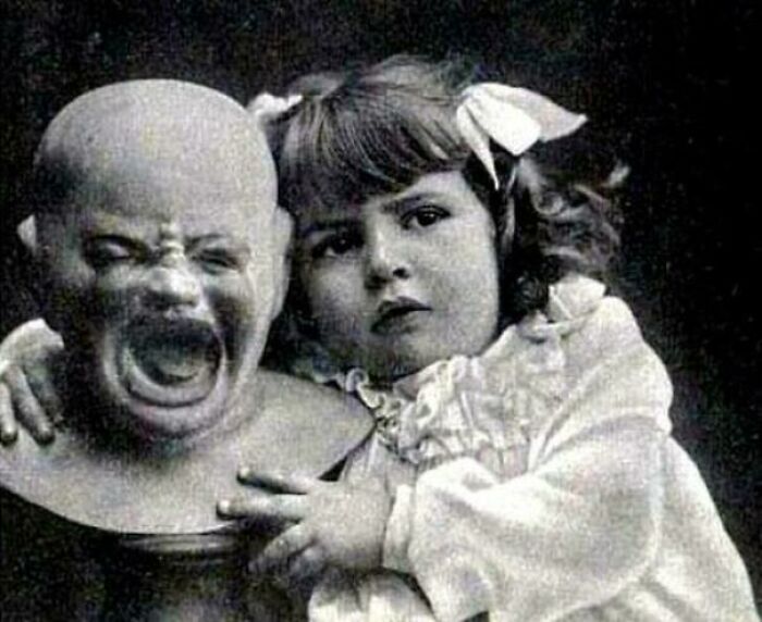 Young Girl With A Very Odd Doll
