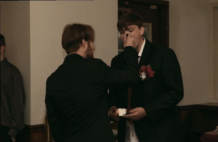 Best Man Feeding Cake To The Groom. Sweet and a Little Silly