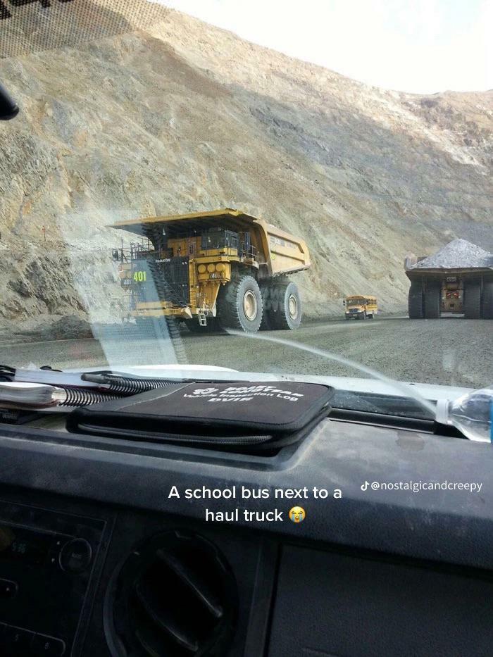 School Bus Next To A Giant Haul Truck—Talk About Size!