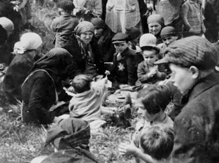 A Jewish Girl Shows Friends A Dandelion Outside The Worst Place Ever—Auschwitz