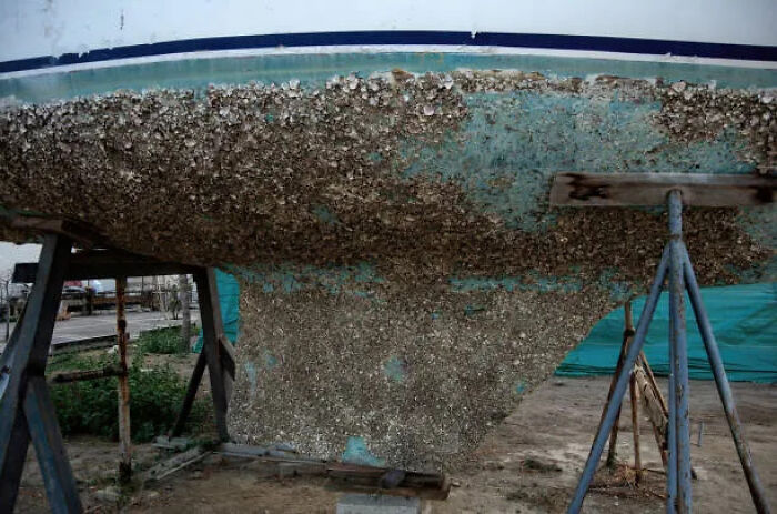 Scraping Barnacles Off Luxury Yacht Props With Pneumatic Chisels