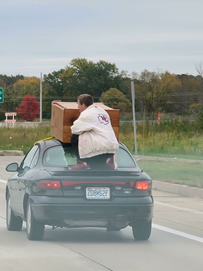 This Guy’s Idea of Road Safety? Holding a Dresser on a Car at 50mph