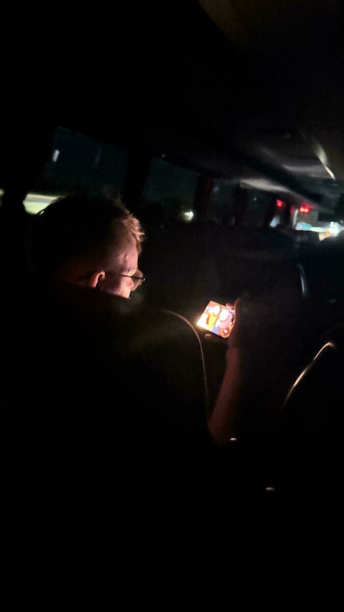 Guy on Overnight Bus with Max Phone Brightness and No Headphones