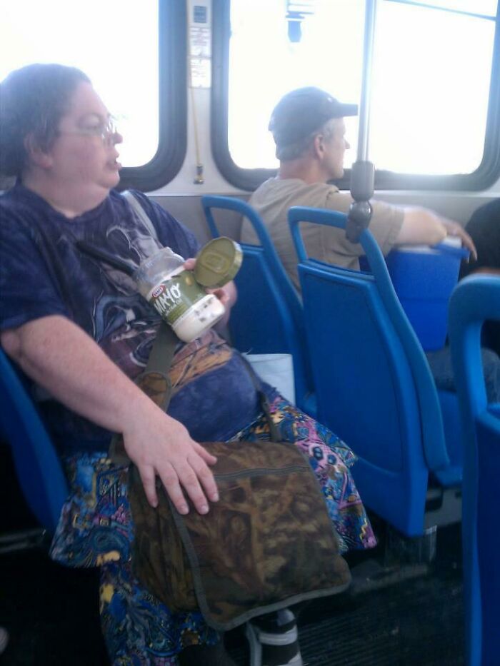 Woman Eating a Tub of Mayonnaise on the Bus
